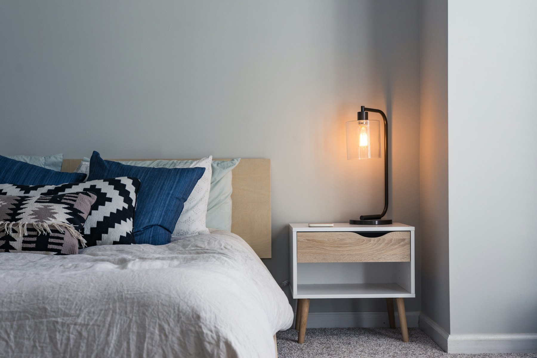A bedroom dressed with printed textiles