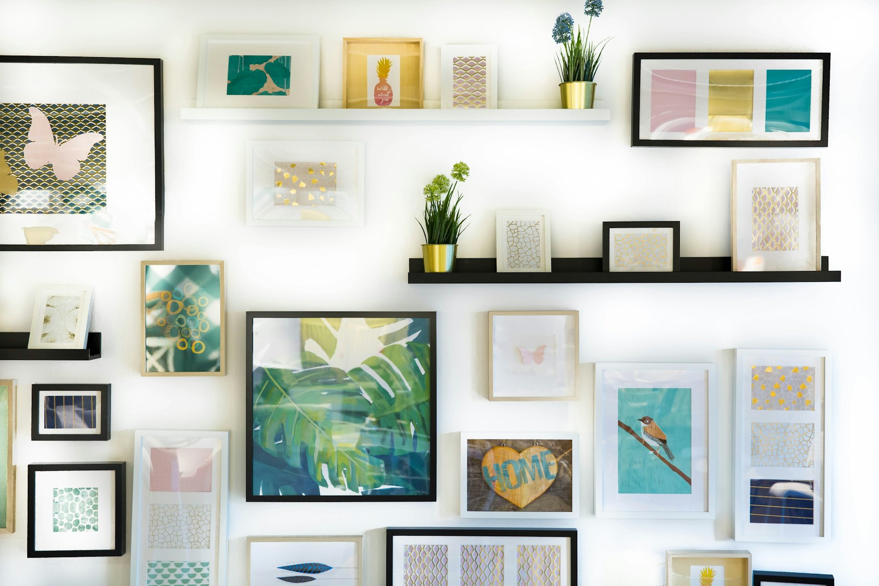 A gallery wall of framed prints in a bright interior